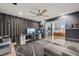 Open-concept room with a desk area, ceiling fan, decorative wood slat wall, and access to another living area at 614 Capital Blvd # 229, Raleigh, NC 27603