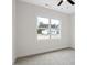 A bedroom offers a ceiling fan and large window allowing lots of natural light at 704 East St, Smithfield, NC 27577