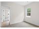 This bedroom features a light, neutral color scheme, natural light, and plush carpeting at 704 East St, Smithfield, NC 27577