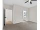 A clean bedroom features neutral carpet, white walls and trim and an entrance to the Primary bathroom at 704 East St, Smithfield, NC 27577