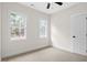Bright bedroom with two windows offering natural light and neutral carpet and fresh paint at 704 East St, Smithfield, NC 27577