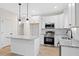 Stylish kitchen with stainless steel appliances, granite island, and pendant lighting at 704 East St, Smithfield, NC 27577