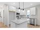 Beautiful kitchen featuring a granite island, stainless steel appliances and hanging lights at 704 East St, Smithfield, NC 27577