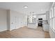 Open kitchen with stainless appliances, granite island, and modern flooring at 704 East St, Smithfield, NC 27577