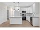 Contemporary kitchen with stainless steel appliances, granite counters, and white cabinetry at 704 East St, Smithfield, NC 27577