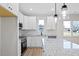 Bright kitchen features white cabinetry, granite countertops, stainless steel appliances, and modern pendant lighting at 704 East St, Smithfield, NC 27577