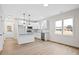 Modern white kitchen with stainless steel appliances and a granite-topped island at 704 East St, Smithfield, NC 27577