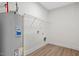 This spacious laundry room is ready with modern wood floors, hookups, and shelving at 704 East St, Smithfield, NC 27577