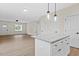 Open concept living room and kitchen, featuring hardwood floors, recessed lighting, and a granite countertop island at 704 East St, Smithfield, NC 27577