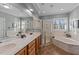 Bright bathroom with double vanity, soaking tub, walk-in shower, and neutral tile at 101 Mantle Dr, Clayton, NC 27527