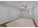 Neutral bedroom features carpet flooring, a ceiling fan, and natural light through a window at 101 Mantle Dr, Clayton, NC 27527