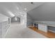 Bright bonus room features built-in bookshelves, desk space, neutral walls and carpet, and recessed lighting at 101 Mantle Dr, Clayton, NC 27527