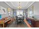 Dining room with dark wood furniture, elegant light fixture, and grey walls at 101 Mantle Dr, Clayton, NC 27527