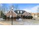Charming brick home with dormers, manicured shrubs, and snowy front lawn at 101 Mantle Dr, Clayton, NC 27527
