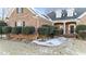 Traditional brick home with a covered front porch and manicured bushes at 101 Mantle Dr, Clayton, NC 27527