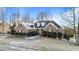 Classic brick home featuring dormer windows, mature landscaping and snow at 101 Mantle Dr, Clayton, NC 27527