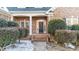 Inviting front porch with brick columns and lush landscaping at 101 Mantle Dr, Clayton, NC 27527