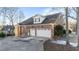 Spacious three-car garage of a brick home with an extended driveway at 101 Mantle Dr, Clayton, NC 27527