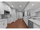 Kitchenette features stainless appliances, white cabinets, granite counters, hardwood flooring, and recessed lights at 101 Mantle Dr, Clayton, NC 27527