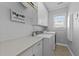 Well-equipped laundry room featuring extra counter space and cabinetry at 101 Mantle Dr, Clayton, NC 27527