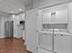 Laundry room features white washer and dryer, white cabinets, and easy access to kitchenette at 101 Mantle Dr, Clayton, NC 27527