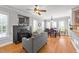 Cozy living room and dining area with a fireplace, large windows, and stylish decor at 101 Mantle Dr, Clayton, NC 27527