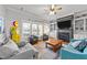 Comfortable living room with gas station decor, fireplace, and large windows at 101 Mantle Dr, Clayton, NC 27527