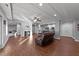 Basement living room features fireplace, laminate wood flooring, access to kitchenette and basement entrance at 101 Mantle Dr, Clayton, NC 27527