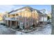 Rear view of a brick two-story house with a large deck and well-maintained yard at 101 Mantle Dr, Clayton, NC 27527