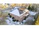 Rear exterior of a brick home with a balcony and snow-covered roof at 101 Mantle Dr, Clayton, NC 27527
