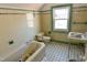 Dated bathroom featuring a tile floor, bathtub, and a sink at 1101 Sunset Ave, Rocky Mount, NC 27804