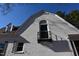Close-up of the home's gable end with decorative window and balcony at 1101 Sunset Ave, Rocky Mount, NC 27804