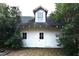 Detached garage featuring a central door, two windows, and lush surrounding greenery at 1101 Sunset Ave, Rocky Mount, NC 27804