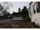 Detached garage adjacent to the house with a black roof and white door and trim at 1101 Sunset Ave, Rocky Mount, NC 27804