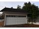 Detached garage with a white door and black roof, surrounded by greenery at 1101 Sunset Ave, Rocky Mount, NC 27804