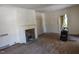 Open living room with a decorative fireplace and hardwood floors at 1101 Sunset Ave, Rocky Mount, NC 27804