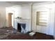 Bright living room featuring a fireplace, built-in shelving, and classic trim at 1101 Sunset Ave, Rocky Mount, NC 27804