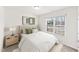 Inviting bedroom with a plush bed, soft lighting, and a window overlooking the outdoors at 115 Dolomite Dr, Gibsonville, NC 27249