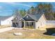 Charming single story home with a two car garage and cozy landscaping at 115 Dolomite Dr, Gibsonville, NC 27249
