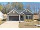 Charming single story home with a two car garage and well manicured front yard at 115 Dolomite Dr, Gibsonville, NC 27249