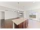 Open concept living space with a granite island, bright light, and dark hardwood floors at 115 Dolomite Dr, Gibsonville, NC 27249