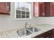 Close up view of sink with stainless steel faucet, undermount sink, and white subway tile backsplash at 115 Dolomite Dr, Gibsonville, NC 27249