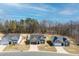 A street view of three homes with well-manicured lawns and driveways on a sunny day at 115 Dolomite Dr, Gibsonville, NC 27249