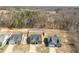 Aerial view of three well-kept homes surrounded by trees and green spaces in a desirable neighborhood at 115 Dolomite Dr, Gibsonville, NC 27249