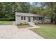 Attractive single-story home featuring green siding, a well-manicured lawn and mature landscaping at 1213 Freeman Dr, Sanford, NC 27330