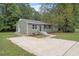 Charming exterior with manicured lawn, updated siding, and concrete driveway at 1213 Freeman Dr, Sanford, NC 27330