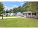 Charming street featuring renovated homes with manicured lawns and mature shade trees at 1213 Freeman Dr, Sanford, NC 27330