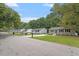 Street view featuring homes with updated siding, mature trees, and well-kept lawns at 1213 Freeman Dr, Sanford, NC 27330