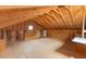 Unfinished attic with plywood floor, exposed beams, and insulation on the walls at 12507 N Roxboro St, Rougemont, NC 27572