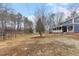 Large backyard with mature trees providing privacy around a charming home at 12507 N Roxboro St, Rougemont, NC 27572